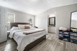 Bedroom featuring light wood-style flooring and ensuite bathroom