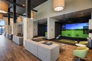 Playroom featuring golf simulator and a high ceiling