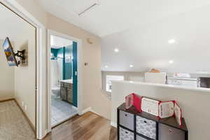 Hallway with light wood finished floors and baseboards