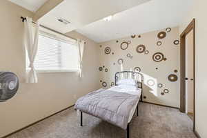 Bedroom featuring carpet flooring and baseboards
