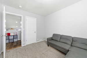 Living area featuring carpet flooring and baseboards