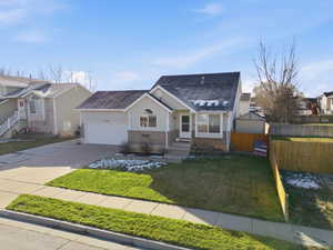 View of front facade with brick siding, concrete driveway, a shingled roof, and an attached garage