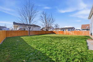 Fenced backyard with a residential view