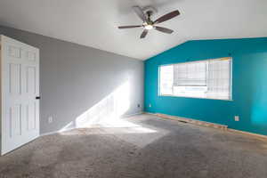 Unfurnished room featuring ceiling fan and carpet