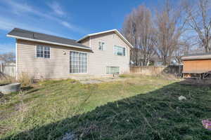 Back of property featuring a fenced backyard and a patio area