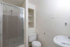 Full bath featuring a stall shower and built in features