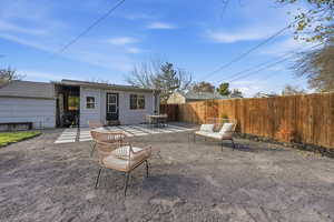 Back of property with a patio, a fenced backyard, and outdoor dining area