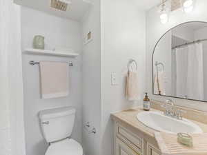Full bath featuring curtained shower and vanity