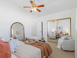 Bedroom featuring carpet flooring, ceiling fan, a closet, and lofted ceiling