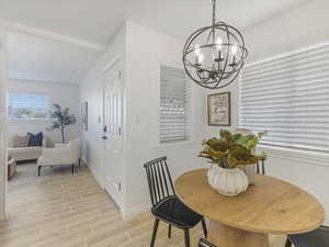 Dining area featuring wood finish floors and a chandelier