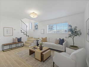 Living room with stairs and wood finish floors