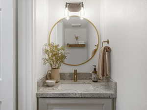 Bathroom featuring vanity and a textured wall