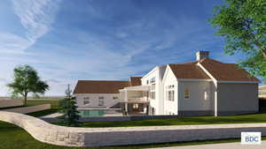 Back of property featuring a balcony, a patio area, a chimney, and a lawn