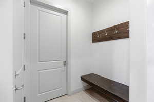 Mudroom featuring light tile patterned flooring and baseboards
