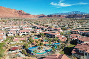 Aerial perspective of suburban area with mountains and a pool area