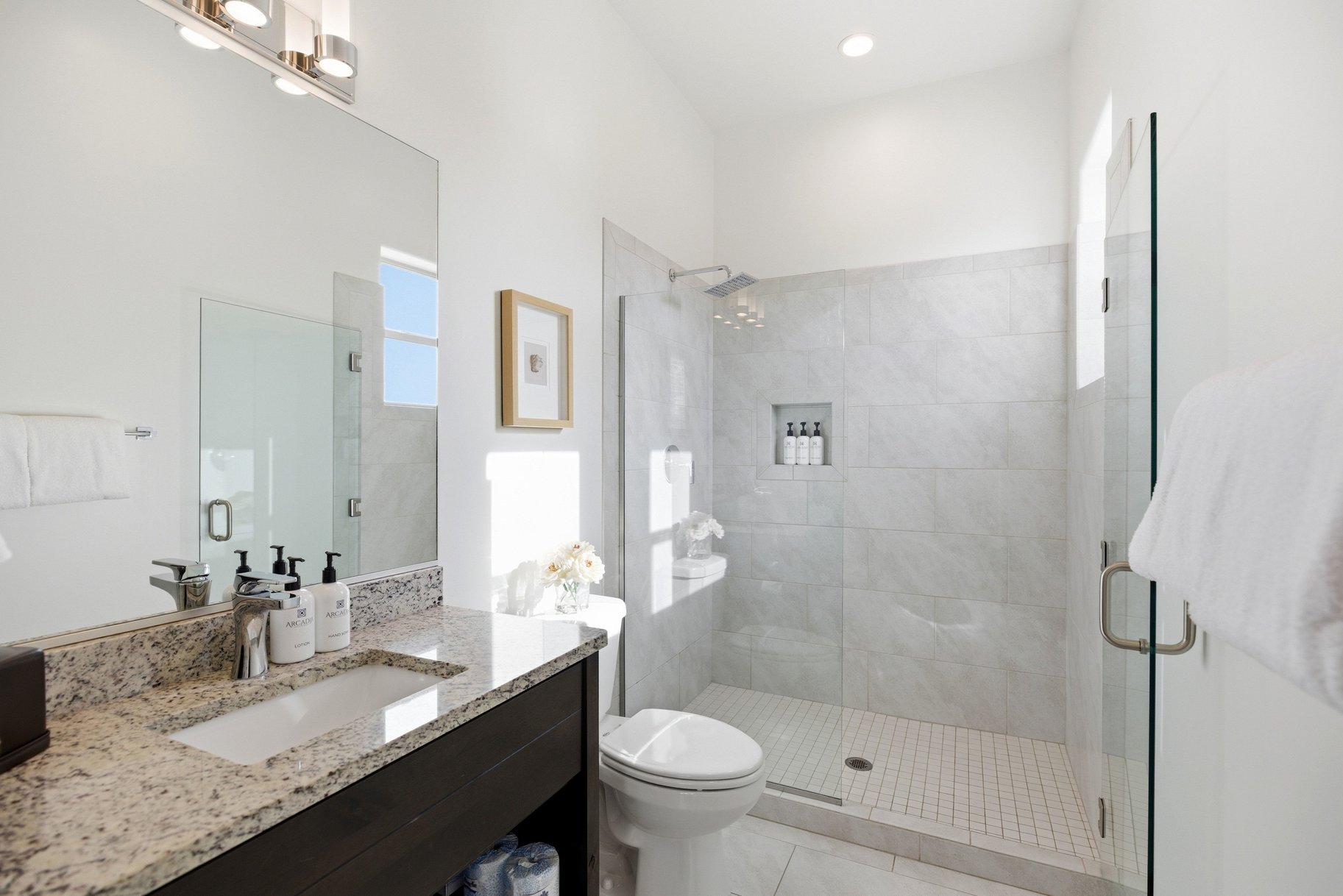 Full bath with a shower stall and vanity