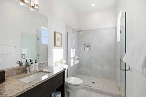 Full bath with a shower stall and vanity