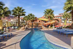 Community pool featuring a patio area and a water slide