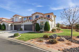 Mediterranean / spanish-style home featuring a front yard, concrete driveway, a garage, and stucco siding