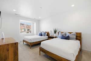 Bedroom featuring light colored carpet and recessed lighting