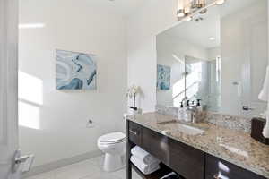 Bathroom featuring vanity, a shower stall, and light tile patterned flooring