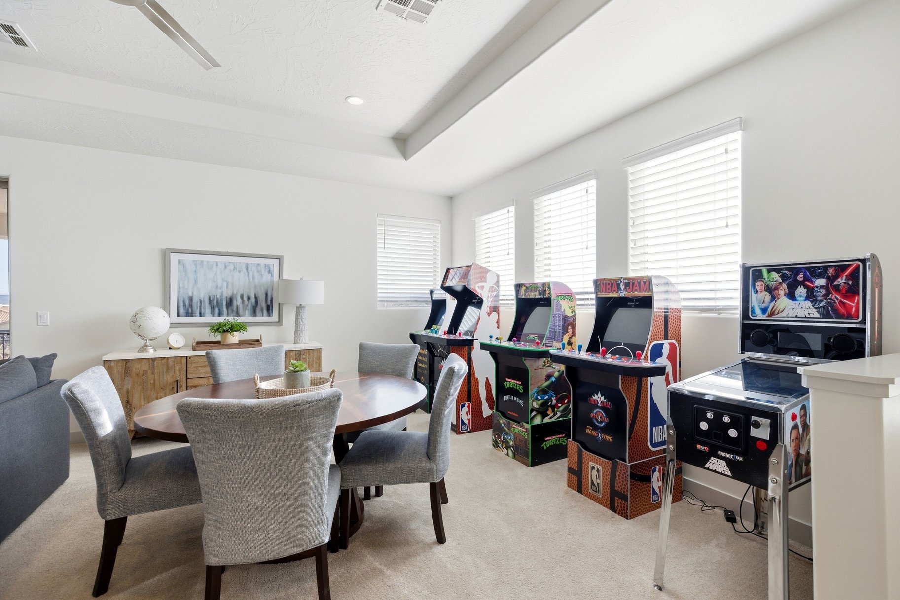 Dining space featuring light carpet, a raised ceiling, recessed lighting, and a ceiling fan