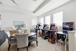 Dining space featuring light carpet, a raised ceiling, recessed lighting, and a ceiling fan