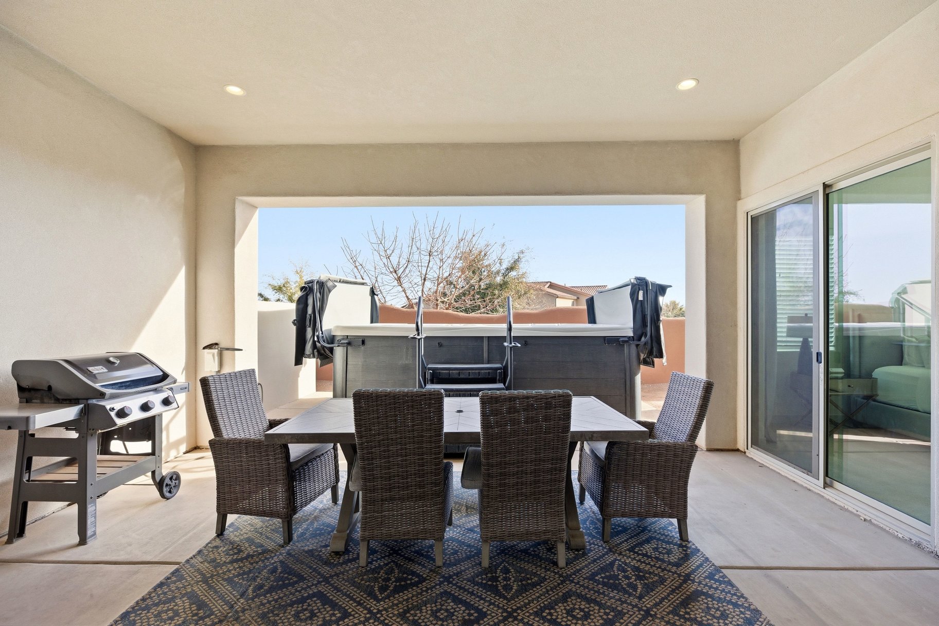 View of patio with outdoor dining area and area for grilling