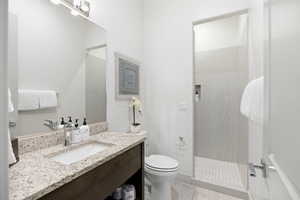 Bathroom with vanity, a walk in shower, and light tile patterned floors