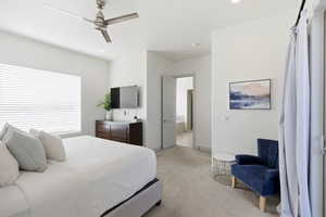 Bedroom with light carpet, a ceiling fan, ensuite bath, and recessed lighting
