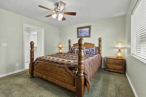 Bedroom with a ceiling fan and carpet flooring