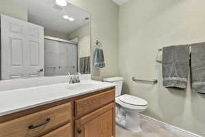 Full bath featuring a shower stall and vanity