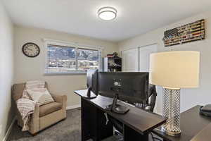 Office space with carpet and baseboards