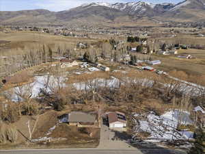 Snowy aerial view with a residential view and a mountain view