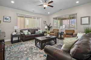 Living room featuring a ceiling fan, recessed lighting, plenty of natural light, vaulted ceiling, and carpet