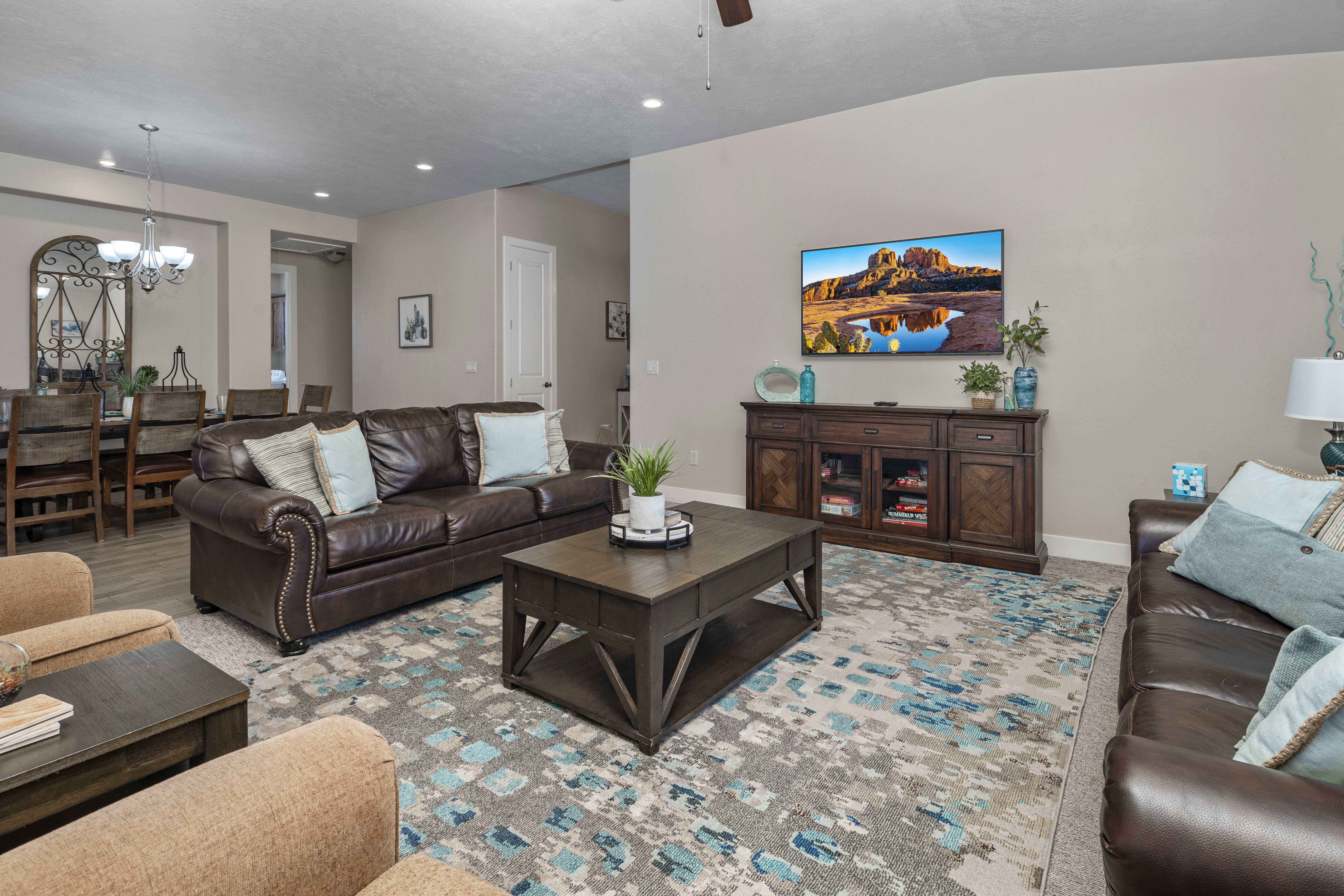 Living room with a chandelier and a ceiling fan