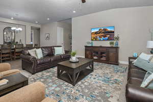 Living room with a chandelier and a ceiling fan