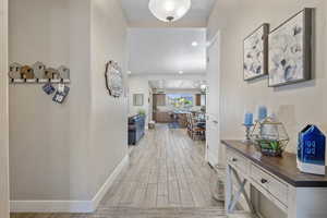 Entry Hallway with wood finish floors and recessed lighting
