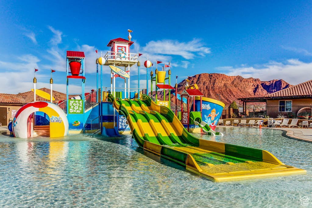 View of jungle gym with a water play area and a mountain view