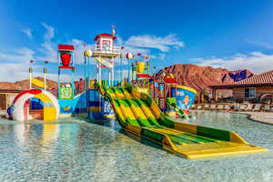 View of jungle gym with a water play area and a mountain view