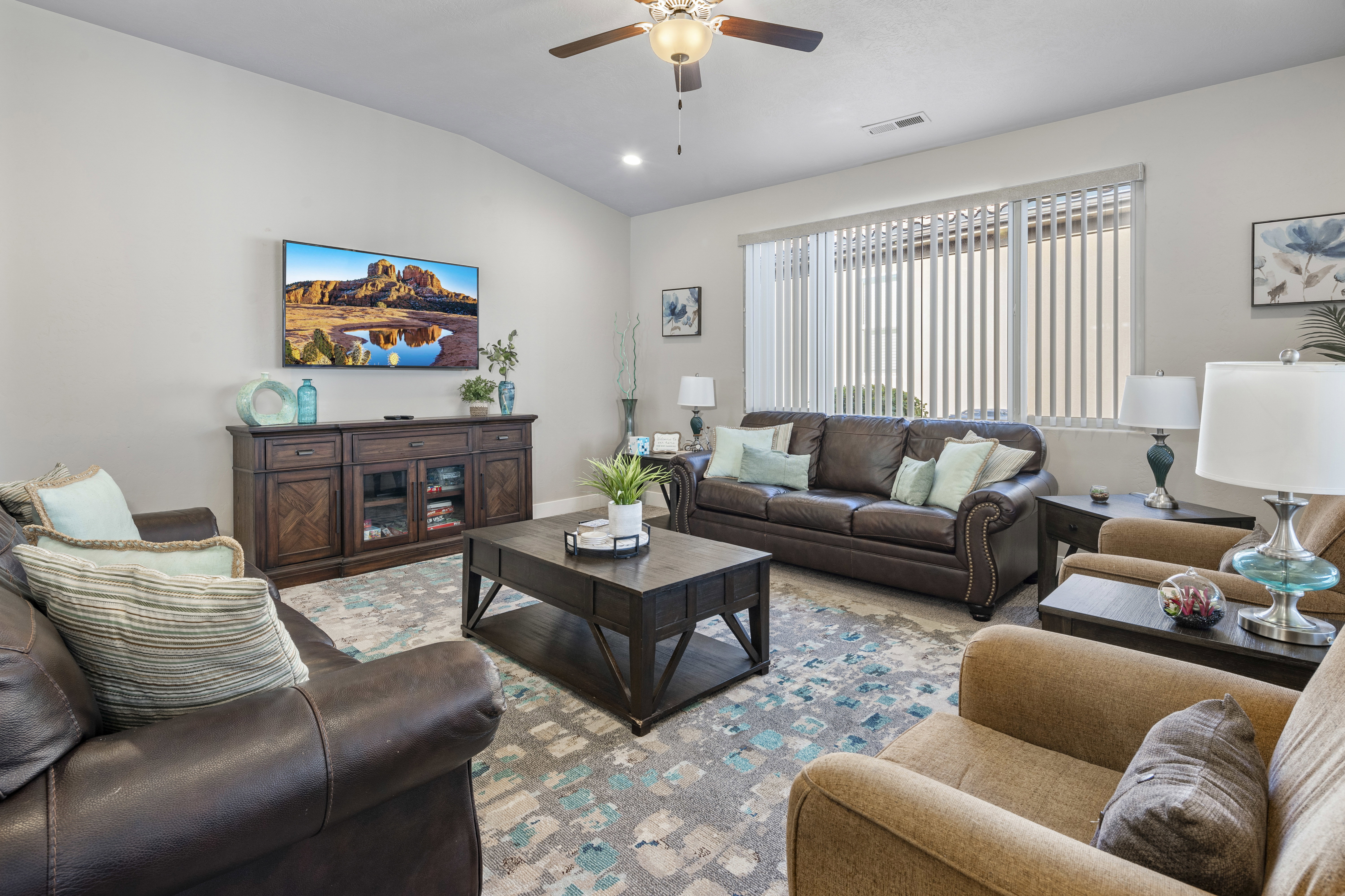 Living room featuring a ceiling fan, vaulted ceiling, and recessed lighting