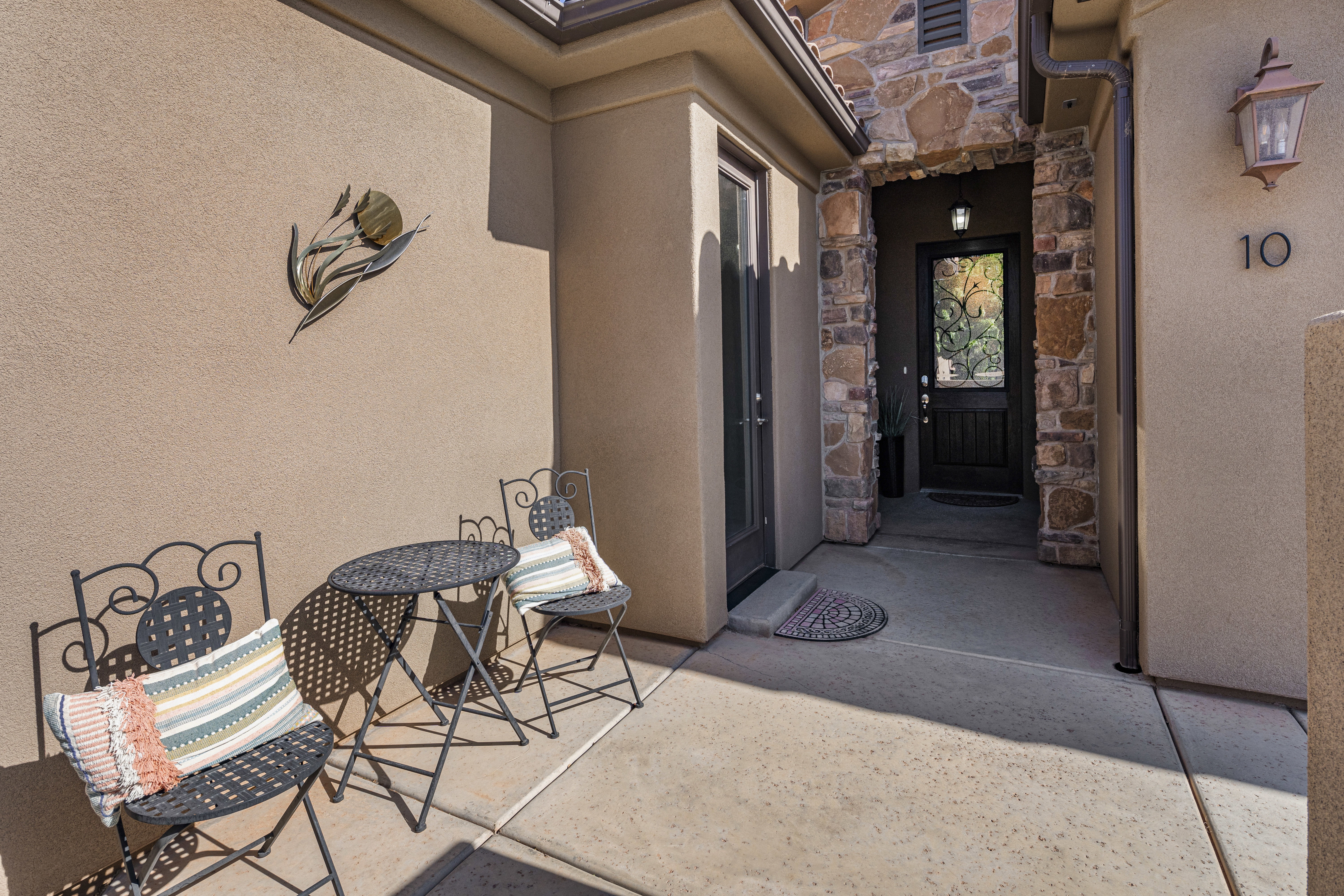 View of exterior entry with stone siding and stucco siding
