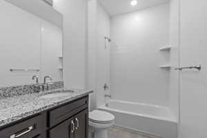 Bathroom with shower / tub combination, vanity, light tile patterned floors, and recessed lighting