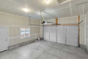 Garage featuring a garage door opener