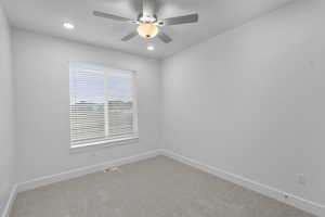 Carpeted empty room featuring recessed lighting and ceiling fan
