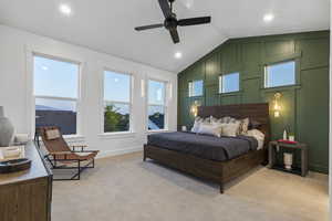 Bedroom with light colored carpet, a ceiling fan, recessed lighting, and a decorative wall