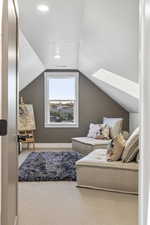 Sitting room featuring wallpapered walls and carpet floors
