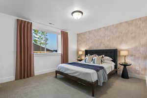 Bedroom featuring carpet floors and an accent wall