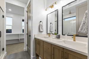 Full bath featuring a shower stall, double vanity, plenty of natural light, a spacious closet, and recessed lighting