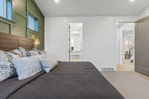 Carpeted bedroom with connected bathroom